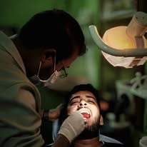 Dentist performing a dental treatment at Soumik's Dental Care